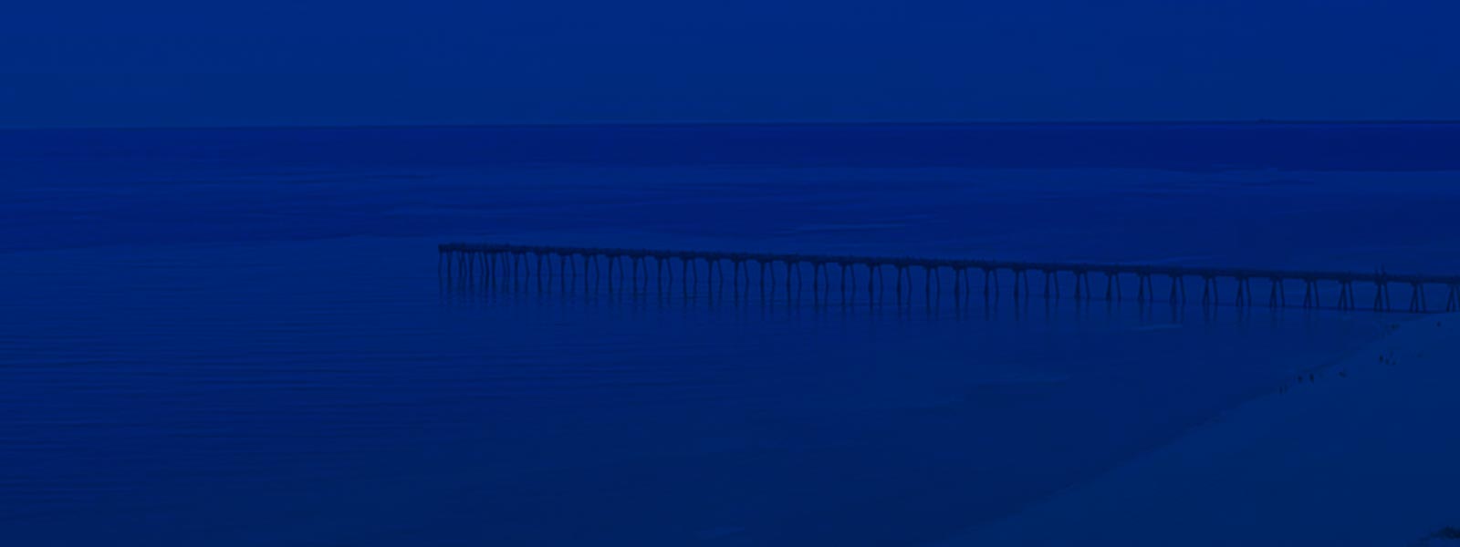 Aerial view of a pier with blue overlay